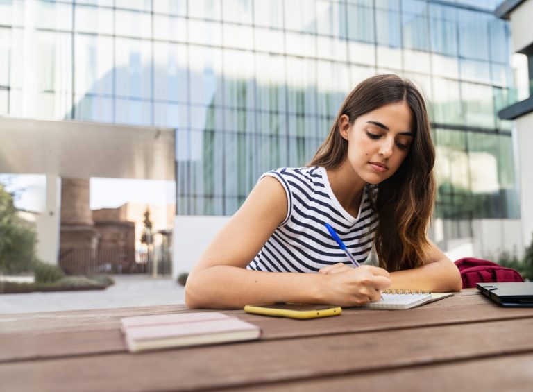woman writing in notebook
