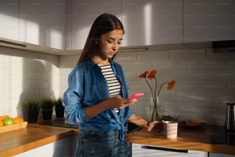 Woman looking for pregnancy help in Colorado on her phone at night